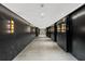Modern hallway with dark marble walls and brass light fixtures at 40 12Th Ne St # 1005, Atlanta, GA 30309