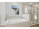 Bathroom with soaking tub, walk-in shower, and window at 29 Riverbirch Ct, Dallas, GA 30157