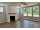 Living room with a farmhouse-style fireplace and hardwood floors at 29 Riverbirch Ct, Dallas, GA 30157