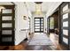 Elegant entry hall with stone flooring, modern light fixture, and access to multiple rooms at 29 Riverbirch Ct, Dallas, GA 30157