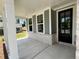 Covered front porch with white columns and a black front door at 29 Riverbirch Ct, Dallas, GA 30157