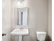 Simple powder room with pedestal sink and toilet at 6035 Spring Way, Stonecrest, GA 30038