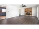 Living room with a stone fireplace, dark flooring, and ceiling fan at 3664 Nessa Se Ct, Smyrna, GA 30082