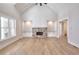 Gathering room with hardwood floors, a stone fireplace, built-in cabinets, and high ceilings at 99 Iroquois Ct, Covington, GA 30014