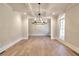 Formal dining room featuring hardwood floors, a chandelier, and large windows at 99 Iroquois Ct, Covington, GA 30014