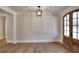 Spacious sitting room with hardwood floors and a wooden door at 99 Iroquois Ct, Covington, GA 30014