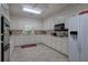 Galley kitchen with white cabinets and modern appliances at 45 Latimer Nw Ln, Cartersville, GA 30121