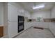Galley kitchen featuring white cabinets and a tile floor at 45 Latimer Nw Ln, Cartersville, GA 30121