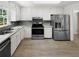 Modern kitchen with stainless steel appliances and white cabinets at 3188 Village Glen Dr, Snellville, GA 30039