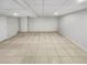 Finished basement offering a large open area with tile floors at 3188 Village Glen Dr, Snellville, GA 30039