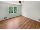Well-lit bedroom with hardwood floors and a large window at 3188 Village Glen Dr, Snellville, GA 30039