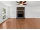 Bright living room features hardwood floors, a brick fireplace, and large windows at 3188 Village Glen Dr, Snellville, GA 30039