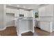 Modern kitchen with white cabinets, granite countertops and island at 6067 Ruby Falls, Stonecrest, GA 30038