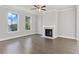 Spacious Gathering room features hardwood floors, fireplace and large windows at 6067 Ruby Falls, Stonecrest, GA 30038