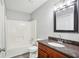 Bathroom with granite countertop, brown vanity, and tub at 4598 Plum Orchard Ln, Stone Mountain, GA 30083