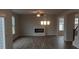 Living room with fireplace, hardwood floors and lots of natural light at 6093 Ruby Falls Way, Stonecrest, GA 30038