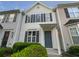 Townhouse exterior featuring a gray door and well-manicured landscaping at 6531 Arbor Gate Sw Dr # 12, Mableton, GA 30126