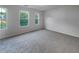Large bedroom with neutral carpeting and three windows at 6531 Arbor Gate Sw Dr # 12, Mableton, GA 30126
