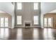 Spacious Gathering room with hardwood floors, fireplace and access to outdoor space at 6175 Grindle Rd, Cumming, GA 30041