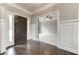 Two-story foyer with hardwood floors and wainscoting at 6175 Grindle Rd, Cumming, GA 30041