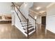 Elegant staircase with dark wood and white railings at 6175 Grindle Rd, Cumming, GA 30041