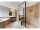 Large walk-in shower with glass enclosure and neutral tile at 6175 Grindle Rd, Cumming, GA 30041