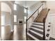 Two-story great room with hardwood floors, fireplace, and large windows at 6175 Grindle Rd, Cumming, GA 30041