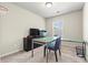 Home office with glass-top desk and neutral decor at 7041 Livia Pt, Riverdale, GA 30296