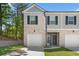 Front view of a two-story townhome at 7041 Livia Pt, Riverdale, GA 30296