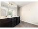 Double vanity bathroom with modern light fixture and mirror at 7041 Livia Pt, Riverdale, GA 30296