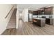 Open concept home with kitchen island and carpeted stairs at 7041 Livia Pt, Riverdale, GA 30296