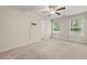 Spacious bedroom with neutral carpeting and ceiling fan at 7041 Livia Pt, Riverdale, GA 30296