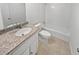 Bathroom with granite countertop, tiled floor, and bathtub at 6520 Roswell Rd # 68, Atlanta, GA 30328