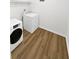 Laundry room with washer, dryer, and wood-look floors at 6520 Roswell Rd # 68, Atlanta, GA 30328