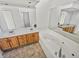 Bathroom with double vanity, jetted tub, and light wood cabinets at 120 Blackberry Run, Fayetteville, GA 30214