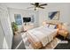 Virtually staged bedroom with a light wood bed frame, carpet flooring, and large windows at 120 Blackberry Run, Fayetteville, GA 30214