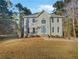 Two-story house with gray siding, blue door and stone accents, set on a grassy lot at 120 Blackberry Run, Fayetteville, GA 30214