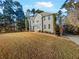 Two-story house with gray siding, and a stone walkway, nestled among trees at 120 Blackberry Run, Fayetteville, GA 30214