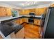 Kitchen with light wood cabinets, granite countertops, and stainless steel appliances at 120 Blackberry Run, Fayetteville, GA 30214
