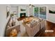 Virtually staged living room with hardwood floors, fireplace, and built-in shelves at 120 Blackberry Run, Fayetteville, GA 30214