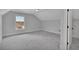 Bedroom with gray carpeting and sloped ceiling at 1356 Flora Dr, Conyers, GA 30094