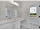 Modern bathroom with white vanity, quartz countertop and large window at 1356 Flora Dr, Conyers, GA 30094