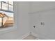 Convenient laundry room with built-in shelving and window at 1356 Flora Dr, Conyers, GA 30094