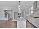 Open kitchen with island, stainless steel appliances, and hardwood floors at 1356 Flora Dr, Conyers, GA 30094