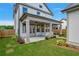Home with covered patio, grassy lawn, and detached garage at 1356 Flora Dr, Conyers, GA 30094