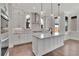 Spacious kitchen with white cabinets, granite island, and stainless steel appliances at 1356 Flora Dr, Conyers, GA 30094