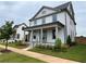 Two-story white house with a front porch and side yard at 1356 Flora Dr, Conyers, GA 30094