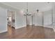 Open dining room with hardwood floors and view into kitchen at 1356 Flora Dr, Conyers, GA 30094
