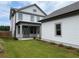 Home with backyard, detached garage, and grassy lawn at 1356 Flora Dr, Conyers, GA 30094