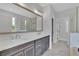 Double vanity bathroom with modern gray cabinets and quartz countertops at 1356 Flora Dr, Conyers, GA 30094